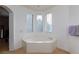 Relaxing bathroom featuring a large soaking tub with natural light from large windows at 6007 Turtle River Ave, Las Vegas, NV 89156