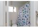 Cozy bathroom featuring a toilet and a shower with a cute seashell-themed shower curtain at 6007 Turtle River Ave, Las Vegas, NV 89156