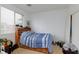 Bedroom with built in shelving near window and blue striped comforter on unmade bed at 6007 Turtle River Ave, Las Vegas, NV 89156