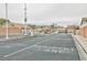 Community entrance with security gate, resident and visitor lanes, and well-kept landscaping at 6007 Turtle River Ave, Las Vegas, NV 89156