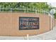 A well-maintained community entrance with attractive 'Heritage' signage and fencing at 6007 Turtle River Ave, Las Vegas, NV 89156