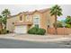 Attractive two-story home featuring a two-car garage, terracotta-tiled roof, and mature palm trees in front at 6007 Turtle River Ave, Las Vegas, NV 89156