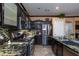 Modern kitchen featuring stainless steel appliances and granite countertops at 6007 Turtle River Ave, Las Vegas, NV 89156