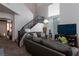 Comfortable living room featuring a staircase and large windows that provide natural light at 6007 Turtle River Ave, Las Vegas, NV 89156