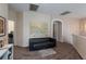Bright loft area with a comfortable black couch and carpet, ideal for relaxation at 6007 Turtle River Ave, Las Vegas, NV 89156