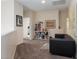 Cozy loft featuring a comfortable black couch and a bookshelf with decor at 6007 Turtle River Ave, Las Vegas, NV 89156