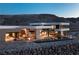 Stunning contemporary home features an infinity pool and outdoor lounge spaces set against a mountain backdrop at 4 Horseshoe Rock Ct, Henderson, NV 89012