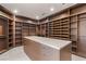 Spacious walk-in closet with custom shelving, drawers, and a center island for ample storage at 4 Horseshoe Rock Ct, Henderson, NV 89012