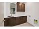 Modern laundry room with dark brown cabinets and a white countertop at 9 Promenade Isle Ln, Henderson, NV 89011