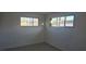 Clean bedroom featuring fresh, white walls, two windows, and light wood-look floors at 2618 Valley St, Las Vegas, NV 89101