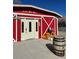 Charming red barn with pumpkins and a barrel in front at 351 Bunarch Rd, Pahrump, NV 89060