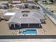Expansive aerial view of a modern home featuring a backyard pool, covered patio, and desert landscaping at 7062 Maverick St, Las Vegas, NV 89131