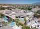 This aerial view shows desert landscaping and the neighborhood featuring a variety of home styles and pools at 7062 Maverick St, Las Vegas, NV 89131