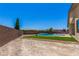 Wide backyard with a pool, privacy wall, and low-maintenance landscaping, perfect for outdoor enjoyment at 7062 Maverick St, Las Vegas, NV 89131