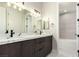 Bathroom featuring dual sinks with stone countertops and modern lighting fixtures at 7062 Maverick St, Las Vegas, NV 89131