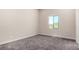 Bedroom with plush carpet and a black framed window providing natural light at 7062 Maverick St, Las Vegas, NV 89131