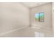 Bright bedroom with white tile flooring and a black framed window offering natural light at 7062 Maverick St, Las Vegas, NV 89131