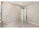 Bright bedroom featuring neutral walls, tile flooring, and a modern door, creating a simple yet elegant space at 7062 Maverick St, Las Vegas, NV 89131