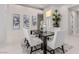 Dining room area with modern table and chairs, tile floors, and large artwork at 7062 Maverick St, Las Vegas, NV 89131
