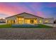 Stunning home exterior at twilight with manicured landscaping and modern architectural design at 7062 Maverick St, Las Vegas, NV 89131