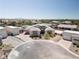 An elevated front view of a desert home with gray tones, brick accents, and desert landscaping at 7062 Maverick St, Las Vegas, NV 89131