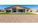 Picturesque home exterior with pristine turf, stucco walls, and a sleek pool at 7062 Maverick St, Las Vegas, NV 89131