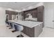 Stylish kitchen with a large center island, barstool seating, modern cabinets and tile flooring at 7062 Maverick St, Las Vegas, NV 89131