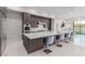 Modern kitchen with large island, stylish seating, sleek cabinetry, and stainless steel appliances at 7062 Maverick St, Las Vegas, NV 89131