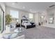 Open main bedroom with sitting area, lots of natural light, neutral carpet and walls, and king size bed at 7062 Maverick St, Las Vegas, NV 89131