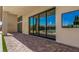 Covered patio featuring sliding glass doors with views of the pool and lush landscaping at 7062 Maverick St, Las Vegas, NV 89131
