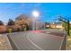 Private backyard basketball court with lights at 7385 Heron Canyon Ct, Las Vegas, NV 89117