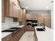 Modern kitchen with wood cabinetry, high-end appliances, and large island at 7385 Heron Canyon Ct, Las Vegas, NV 89117