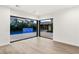 Living room with sliding glass doors showcasing a pool and waterfall at 7385 Heron Canyon Ct, Las Vegas, NV 89117