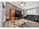 Comfortable living room with wood accent wall, ceiling fan, and plush seating at 8275 W Craig Rd, Las Vegas, NV 89129