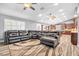 Open-concept living area with hardwood floors and comfortable seating area adjacent to a modern kitchen at 8275 W Craig Rd, Las Vegas, NV 89129