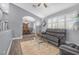 Inviting living room with plantation shutters, wood-look flooring, and a glimpse of the dining area at 8275 W Craig Rd, Las Vegas, NV 89129