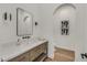 Modern bathroom with a single sink vanity and wood cabinets at 9880 Dorrell Ln, Las Vegas, NV 89149