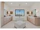 Spa-like bathroom with double vanity and a freestanding tub at 9880 Dorrell Ln, Las Vegas, NV 89149