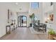 Elegant dining room with hardwood floors and large arched windows at 9880 Dorrell Ln, Las Vegas, NV 89149