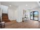 Bright entryway with hardwood floors, modern console table, and staircase at 9880 Dorrell Ln, Las Vegas, NV 89149