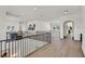 Open second floor hallway with hardwood floors and metal railing at 9880 Dorrell Ln, Las Vegas, NV 89149