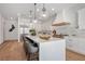 Modern kitchen with white cabinetry, large island, and stainless steel appliances at 9880 Dorrell Ln, Las Vegas, NV 89149