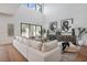 Comfortable living room with hardwood floors, stylish furniture, and natural light at 9880 Dorrell Ln, Las Vegas, NV 89149