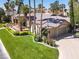 Single-Gathering home with a large yard, three-car garage, and palm trees at 1813 Skyline Dr, Las Vegas, NV 89117