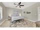 Bright bedroom with ceiling fan, wood-look floors, and artwork at 1813 Skyline Dr, Las Vegas, NV 89117