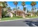 Stunning curb appeal: two-story home with a tile roof, palm trees, and a manicured lawn at 1813 Skyline Dr, Las Vegas, NV 89117