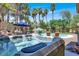 Modern hot tub surrounded by lush landscaping and palm trees at 1813 Skyline Dr, Las Vegas, NV 89117