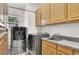 Laundry room with washer, dryer, cabinets, and granite countertop at 1813 Skyline Dr, Las Vegas, NV 89117