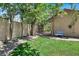 Landscaped side yard with a gate and a blue bench at 1813 Skyline Dr, Las Vegas, NV 89117