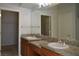 Double vanity bathroom with granite countertops and large mirror at 4727 Wild Draw Dr, North Las Vegas, NV 89031